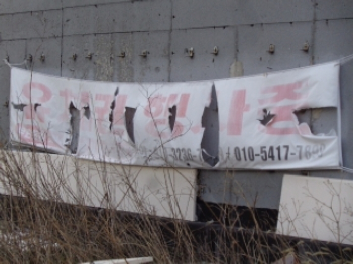 제시외 건물(ㄱ) 외벽에 `유치권 행사중`현수막