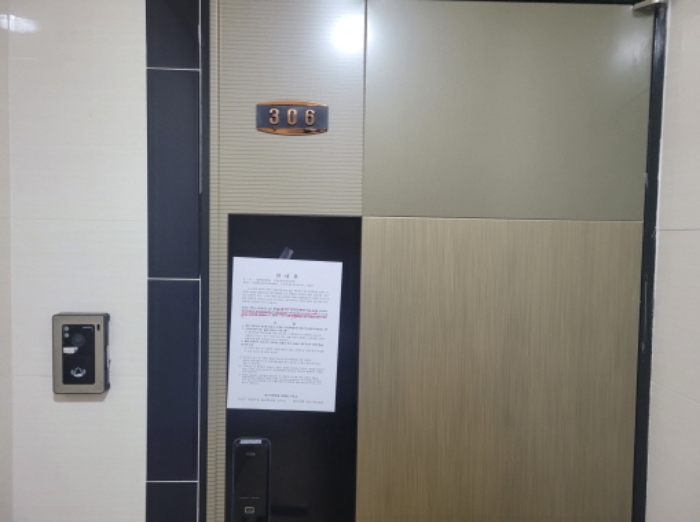306호 현관문에 안내문 부착함.