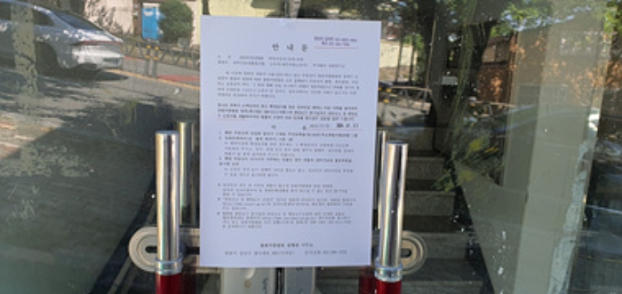 1층왼쪽 출입문에 부동산경매 사건에 대한 안내문 부착(5/14)